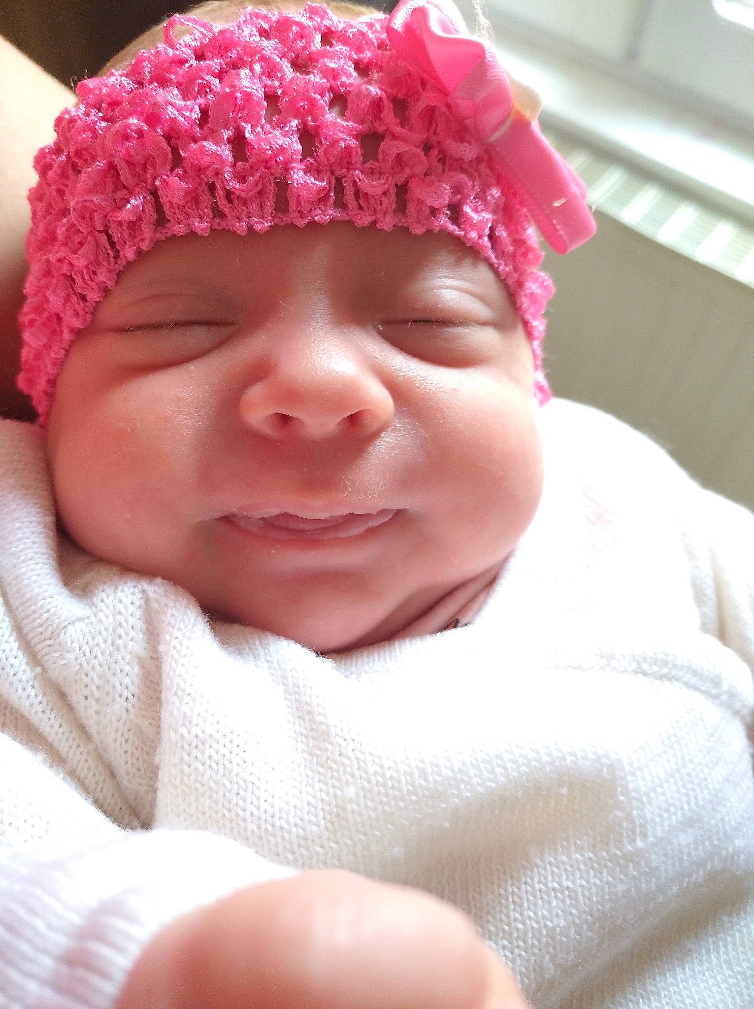 Lyah participe au concours pour gagner de l'argent avec cette photo : baby, bonnet, cheek, child, chin, close_up, face, facial_expression, fashion_accessory, hair_accessory, hat, head, headgear, lip, mouth, nose, person, pink, skin, smile