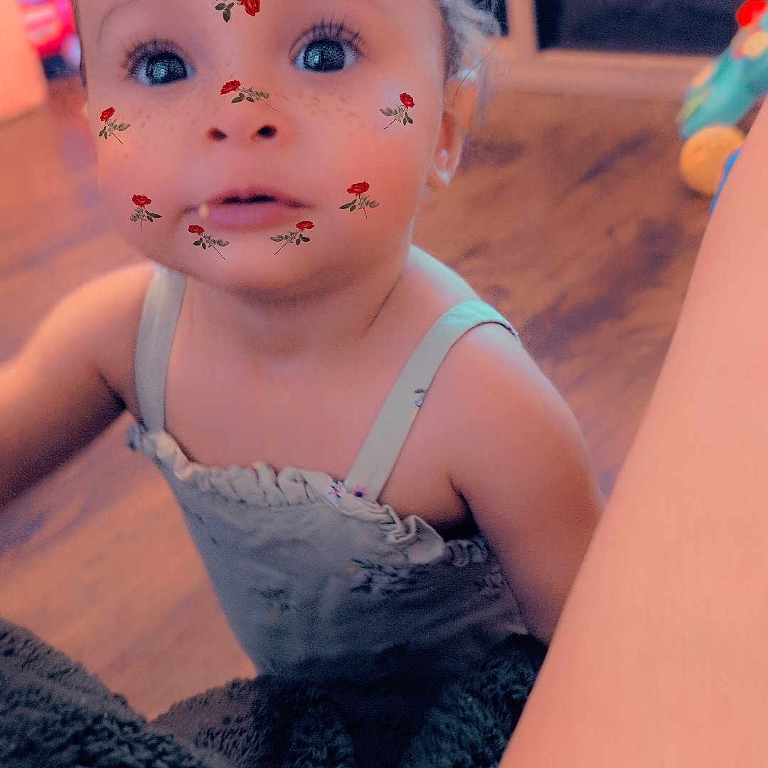 Nova is registered to the contest to win money with this photo: baby, blanket, casual_clothing, child, curious, cute, face, home, indoor, person, portrait, rose_filter, ruffled_clothing, small_child, soft_lighting, tattoo_filter, toddler, wide_eyes, wooden_floor, young_child