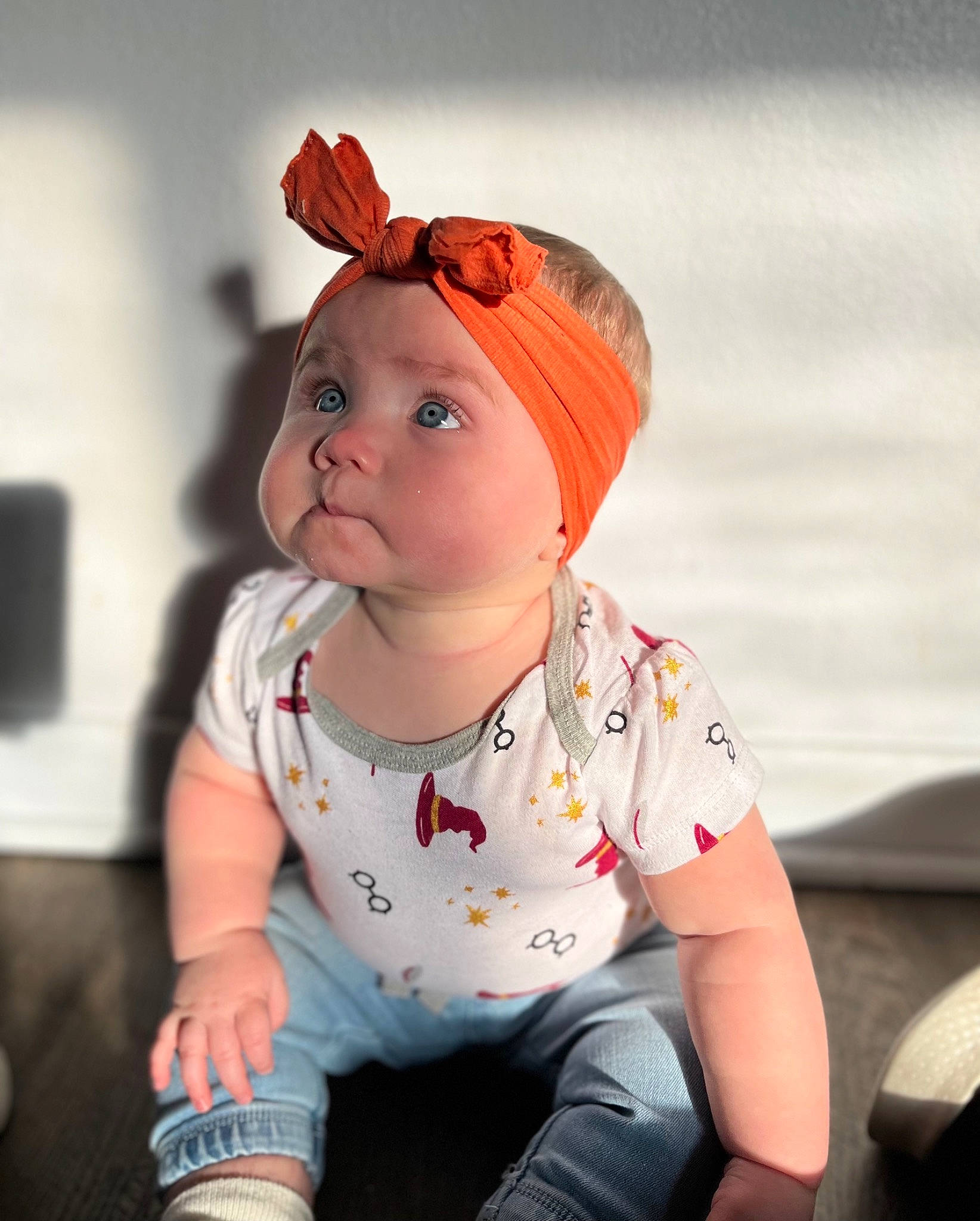 Emmy joined the competition — help win amazing prizes! baby, baby_toddler_clothing, cap, cheek, child, fashion_accessory, flash_photography, flooring, fun, happy, headwear, human_leg, knee, lip, pattern, peach, person, portrait_photography, sitting, sleeve