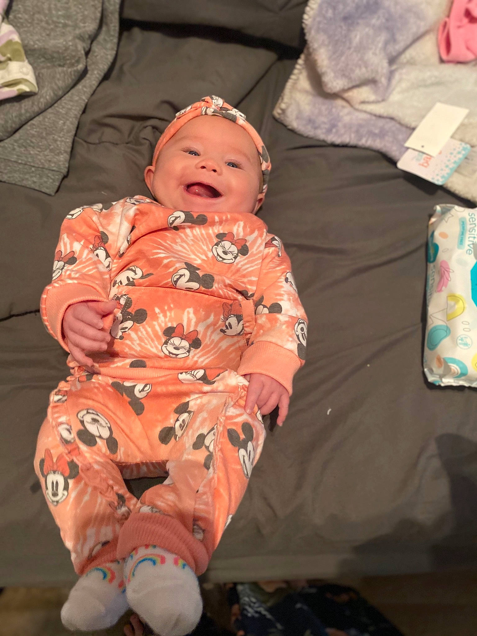 Emmy is registered to the contest to win money with this photo: baby, baby_toddler_clothing, carmine, cheek, child, comfort, event, fun, happy, hat, lap, linens, mouth, person, pink, room, sitting, skin, smile, textile