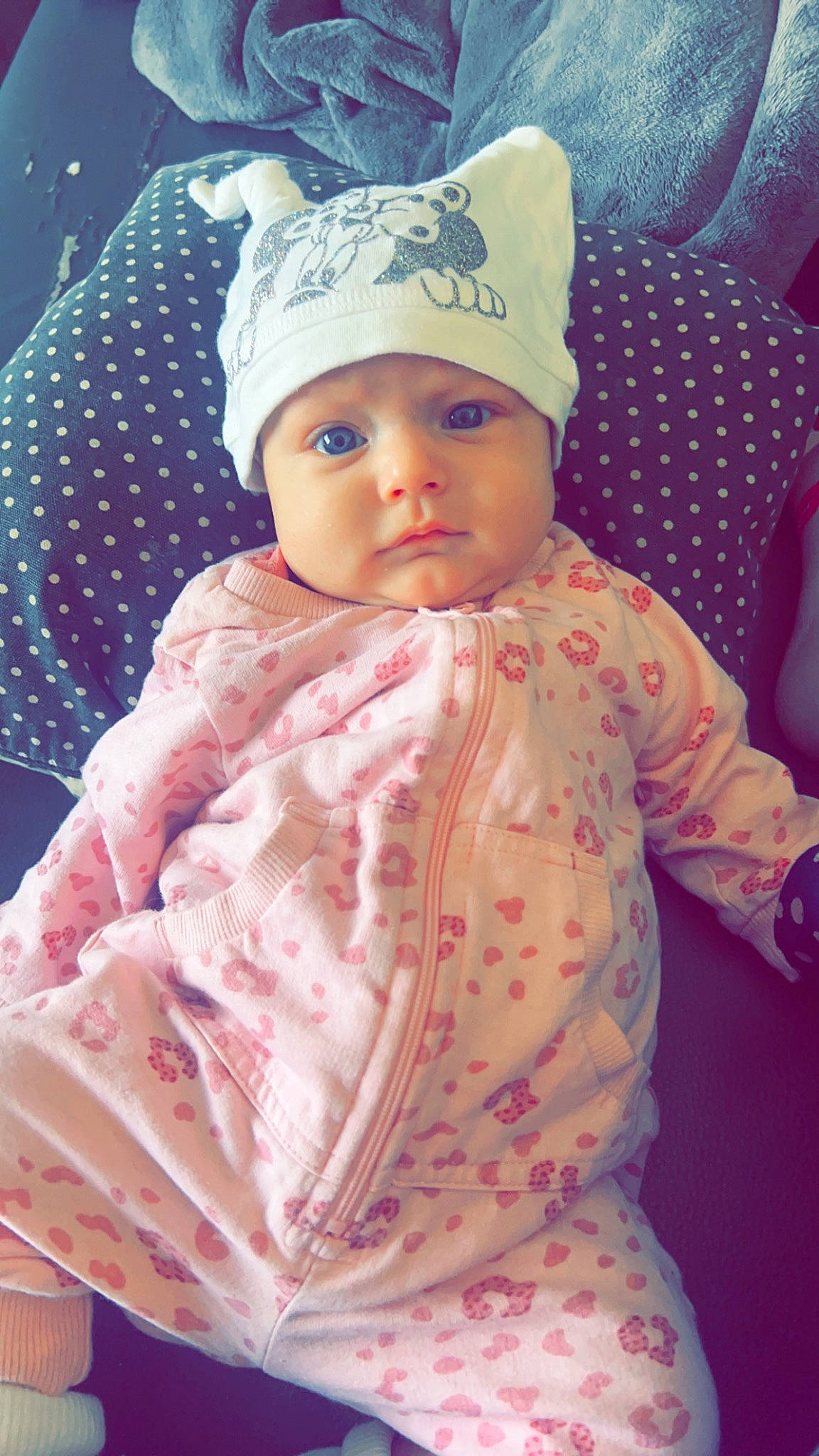 Inaya participe au concours pour gagner de l'argent avec cette photo : baby, baby_products, baby_toddler_clothing, cap, cheek, child, dress, fashion_accessory, happy, headwear, knit_cap, lip, magenta, outerwear, pattern, person, pink, skin, sleeve, textile