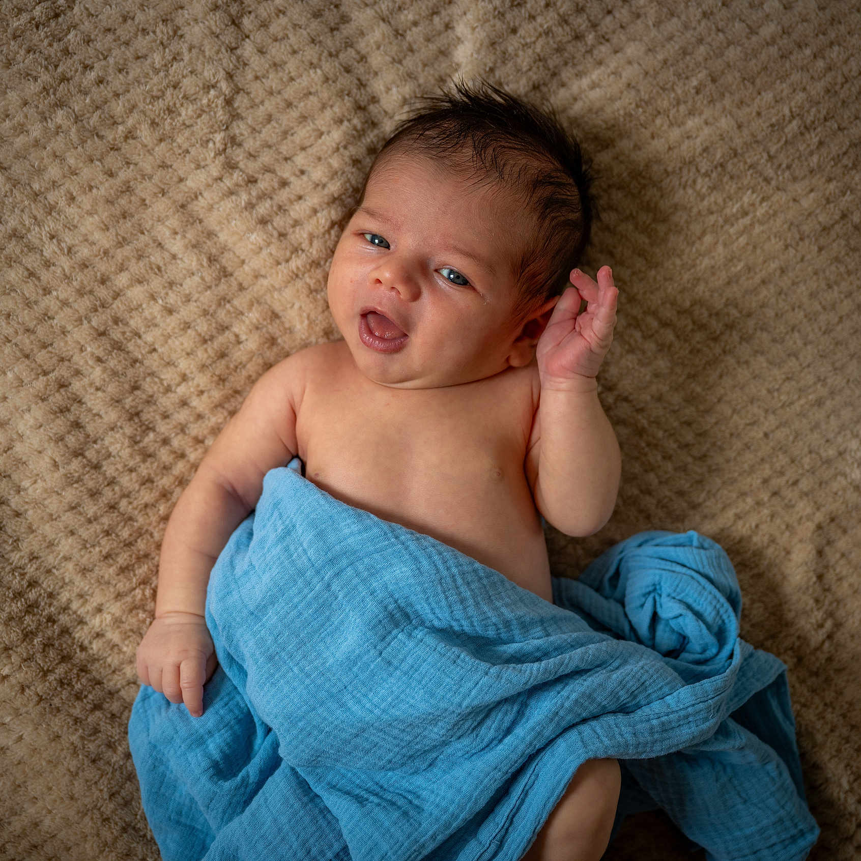 Viktor is registered to the contest to win money with this photo: baby, blanket, blue_blanket, child, closeup, comfort, curly_hair, cute, expression, eyes, face, hand, indoors, infant, lying_down, newborn, portrait, resting, skin, soft_texture