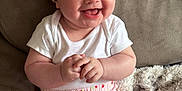 Myla joined the competition — help win amazing prizes! baby, infant, smiling, headband, bow, white_onesie, pink_shorts, strawberry_pattern, socks, couch, blanket, soft_fabric, happy, cute, child, indoors, portrait, sitting, skin, face
