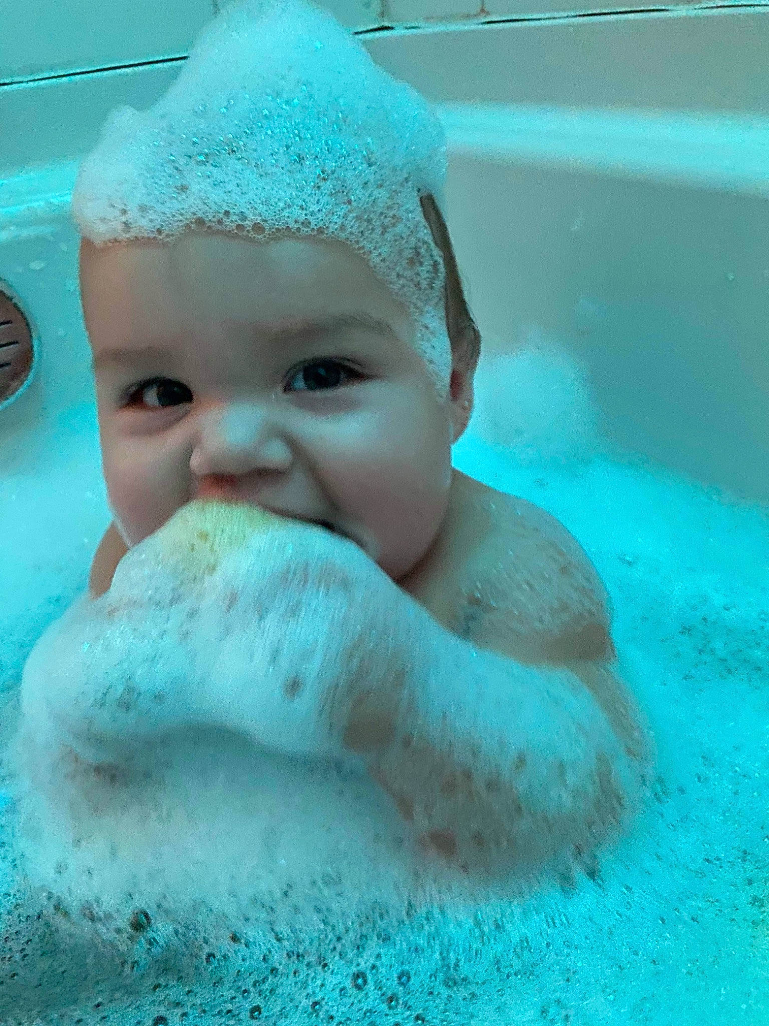 Julian is registered to the contest to win money with this photo: aqua, baby, bathing, blue, cap, child, eye, fashion_accessory, fun, happy, headgear, headwear, leisure, mechanical_fan, person, recreation, skin, swimming_pool, toddler, underwater