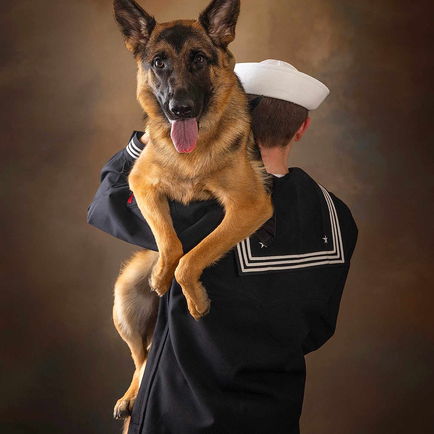 Koda Marie is registered to the contest to win money with this photo: dog, german_shepherd, sailor, uniform, pet, animal, portrait, studio, brown_background, happy, tongue_out, holding, person, back_view, military, friendship, companion, cute, ears_up, fur
