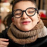 Haroun participe au concours pour gagner de l'argent avec cette photo : child, boy, glasses, scarf, smile, face, portrait, indoor, cozy, warm, clothing, expression, cute, young, person, fashion, happy, head, closeup, casual