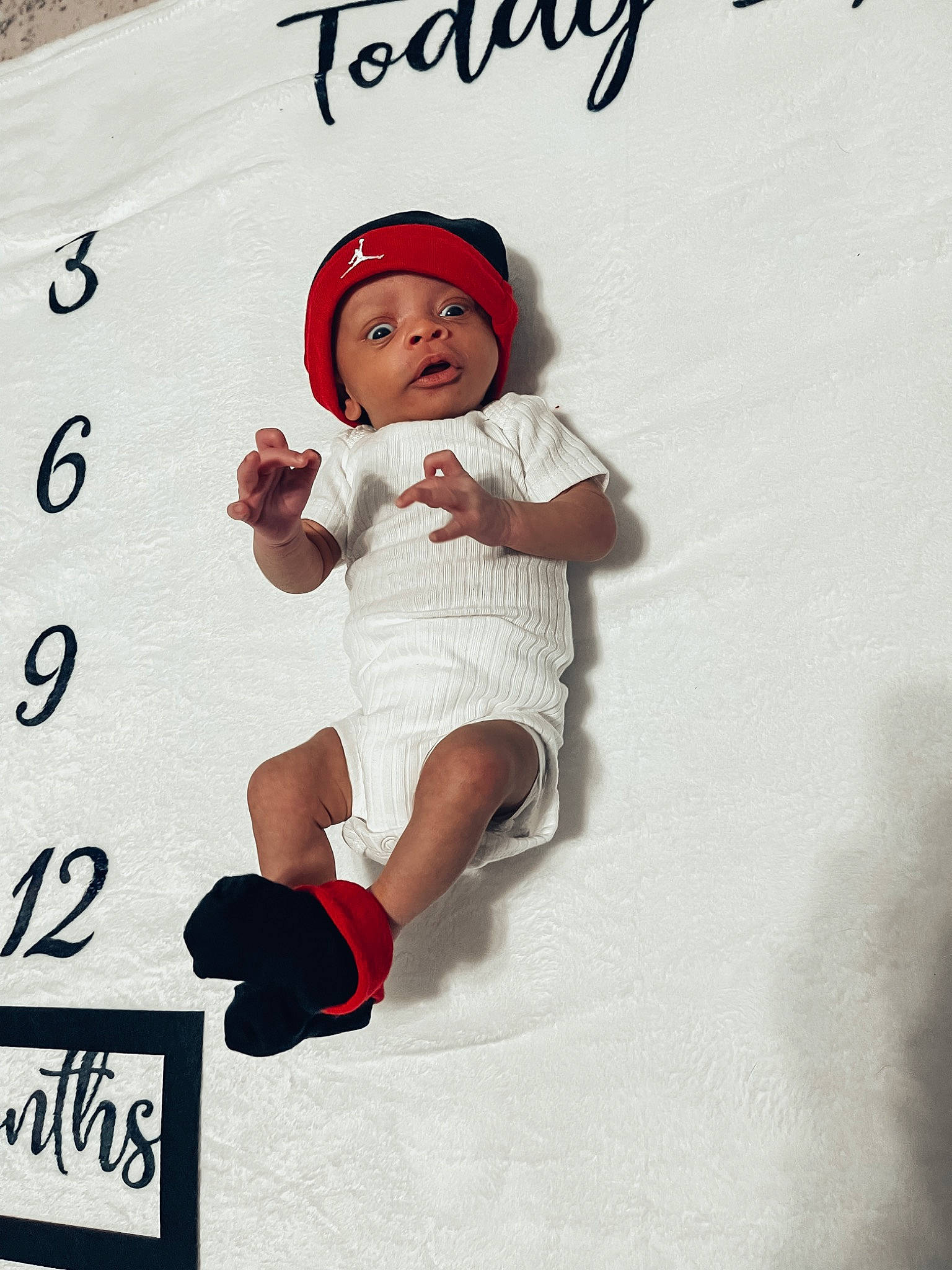 Travon is registered to the contest to win money with this photo: baby, baby_toddler_clothing, cap, carmine, child, fictional_character, font, fun, happy, hat, headwear, knee, magenta, pattern, person, play, recreation, sleeve, sock, t_shirt