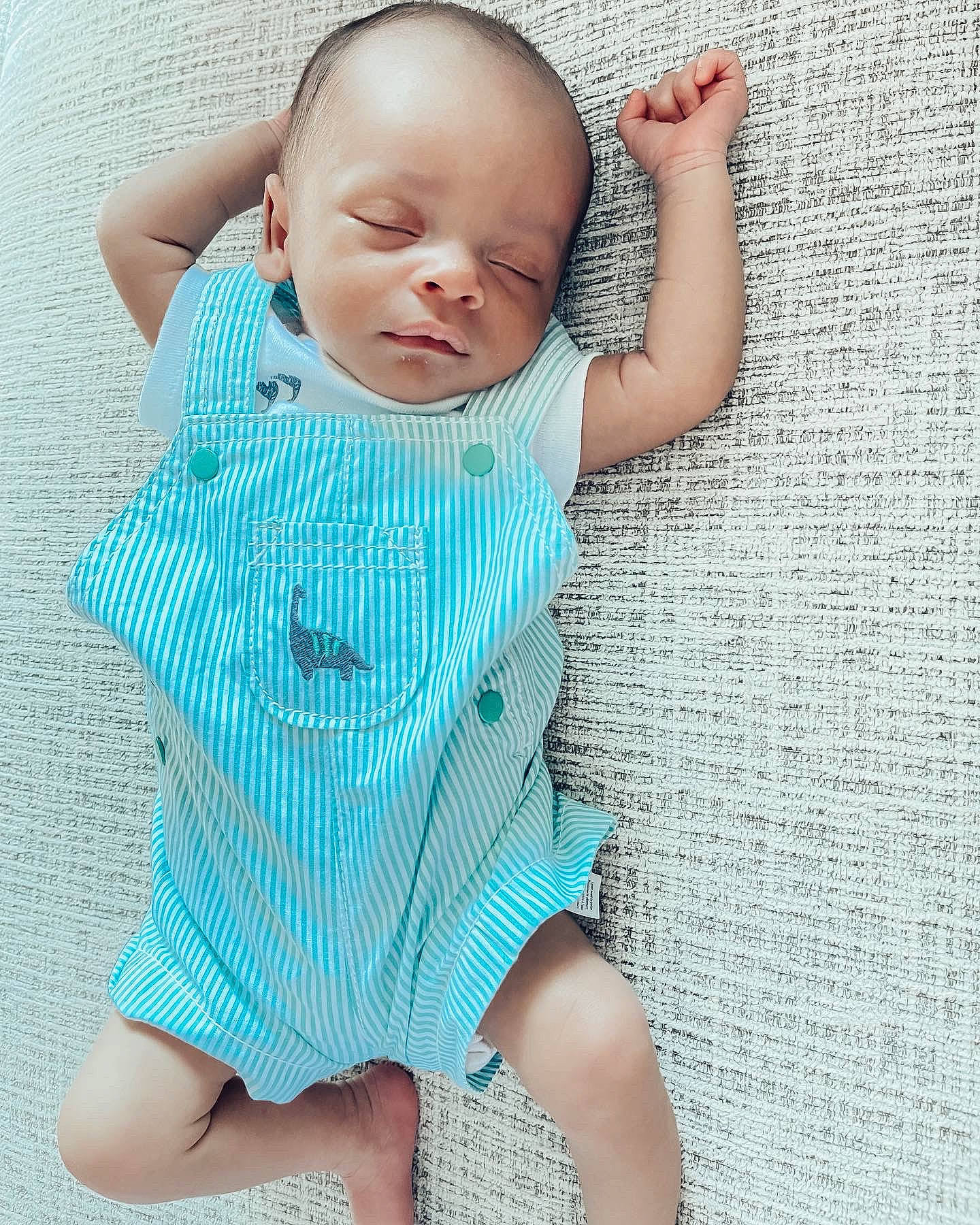 Travon is registered to the contest to win money with this photo: aqua, arm, azure, baby, baby_toddler_clothing, child, collar, comfort, finger, hand, happy, joint, neck, pattern, person, photograph, shoulder, skin, sleeve, textile