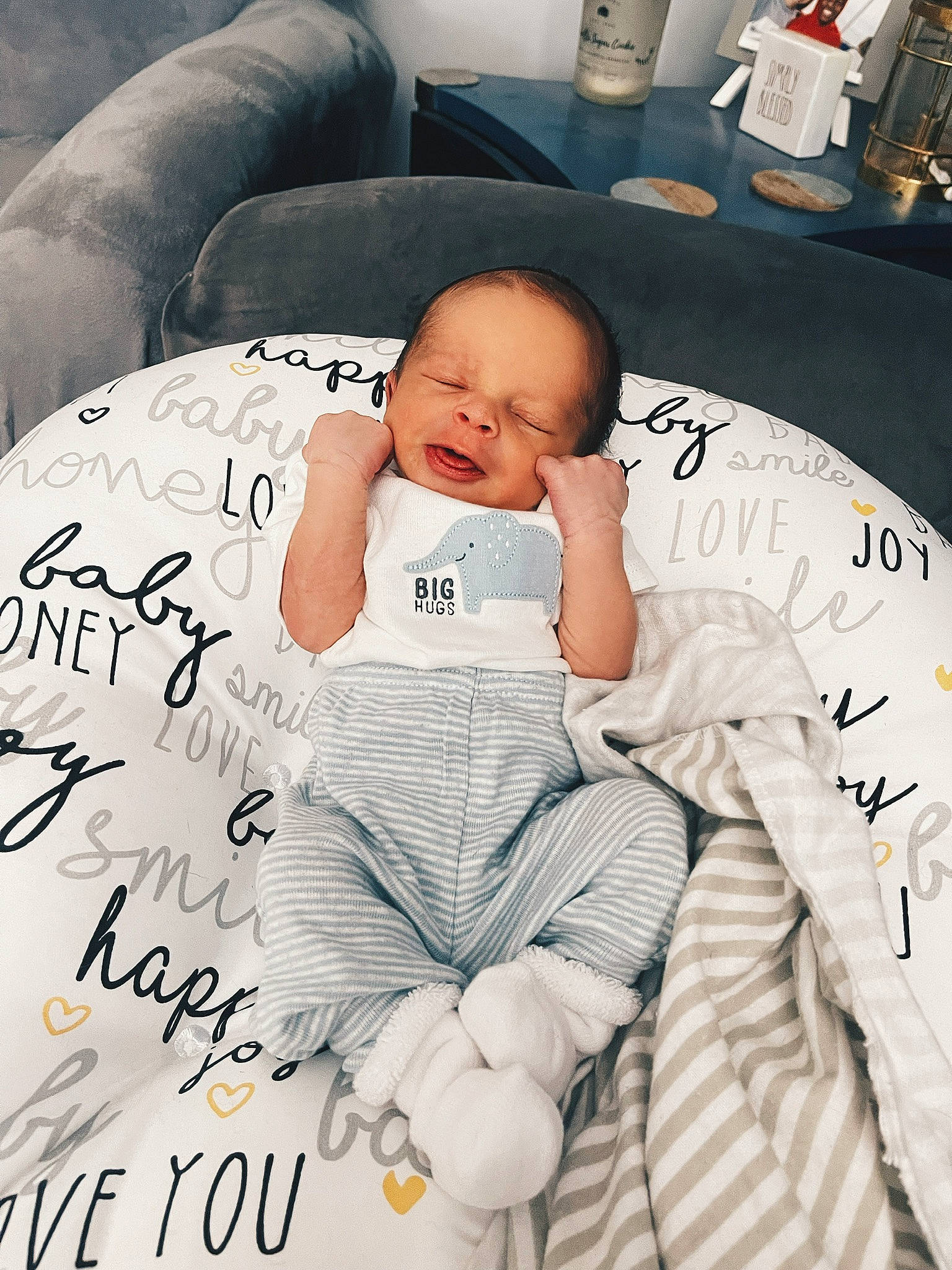 Travon joined the competition — help win amazing prizes! baby, baby_products, baby_toddler_clothing, child, comfort, couch, facial_expression, flooring, font, happy, linens, pattern, person, product, sitting, sleeve, t_shirt, textile, thigh, toddler