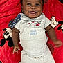 Khalil is registered to the contest to win money with this photo: baby, smiling, infant, lying_down, red_blanket, mickey_mouse, clothing, dimples, happy, face, child, cute, blue_eyes, onesie, fabric, soft, indoors, portrait, person, toddler