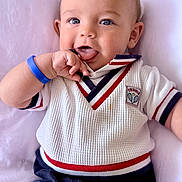 Oakley joined the competition — help win amazing prizes! baby, infant, child, blue_eyes, white_sweater, red_stripes, navy_stripes, shorts, playing, tongue_out, cute, smiling, cushion, soft, indoors, portrait, hand_near_mouth, happy, casual_clothing, closeup