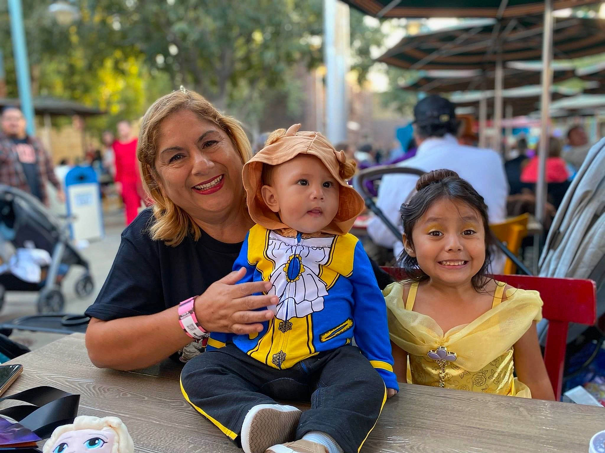 Leilani joined the competition — help win amazing prizes! baby, blurred, chair, child, crowd, event, fun, happy, hat, headwear, joy, leisure, person, public_event, recreation, sitting, smile, summer, sun_hat, t_shirt
