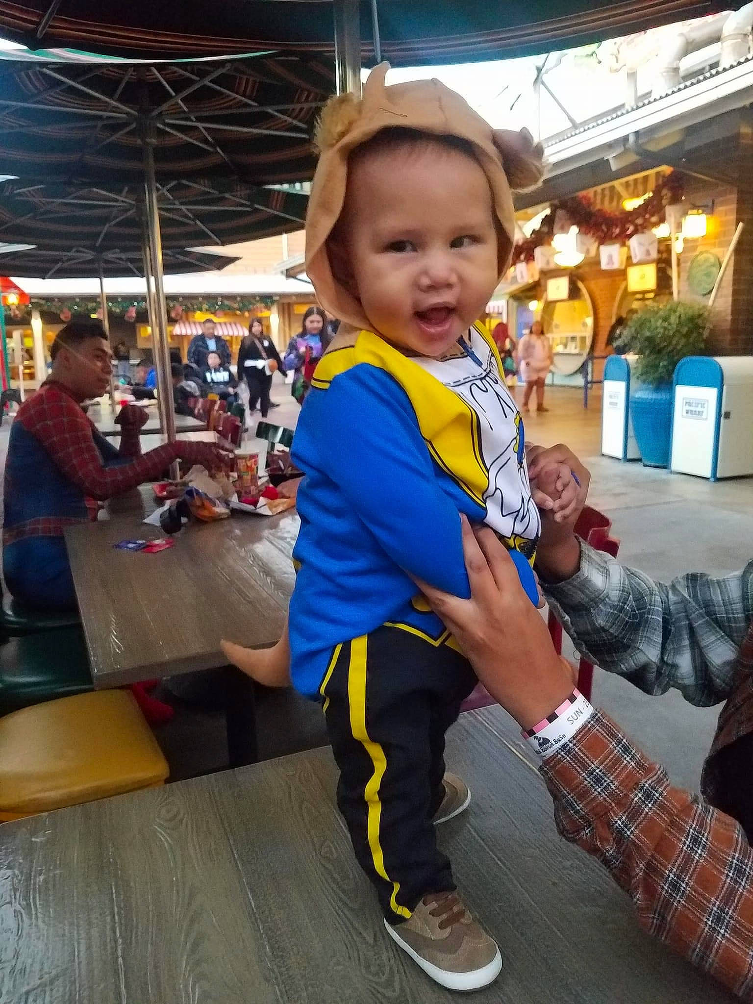 Leland is registered to the contest to win money with this photo: baby, bag, blurred, child, city, customer, event, fashion, fashion_accessory, fun, happy, leisure, luggage_and_bags, market, marketplace, person, recreation, retail, shopping, t_shirt