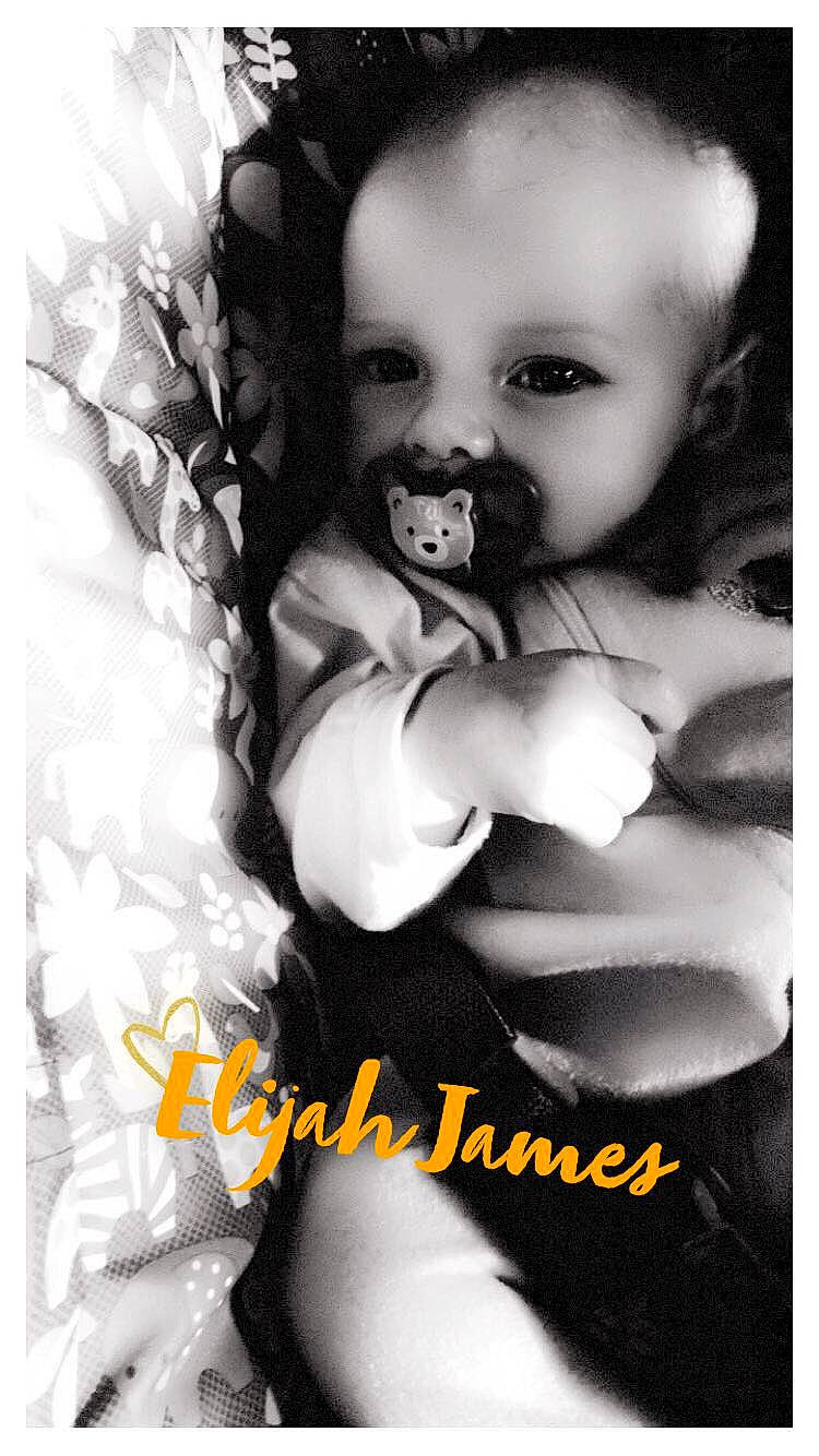 Elijah is registered to the contest to win money with this photo: baby, black_and_white, child, gesture, happy, monochrome, monochrome_photography, person, photo_caption, photograph, photography, smile, stock_photography, toddler