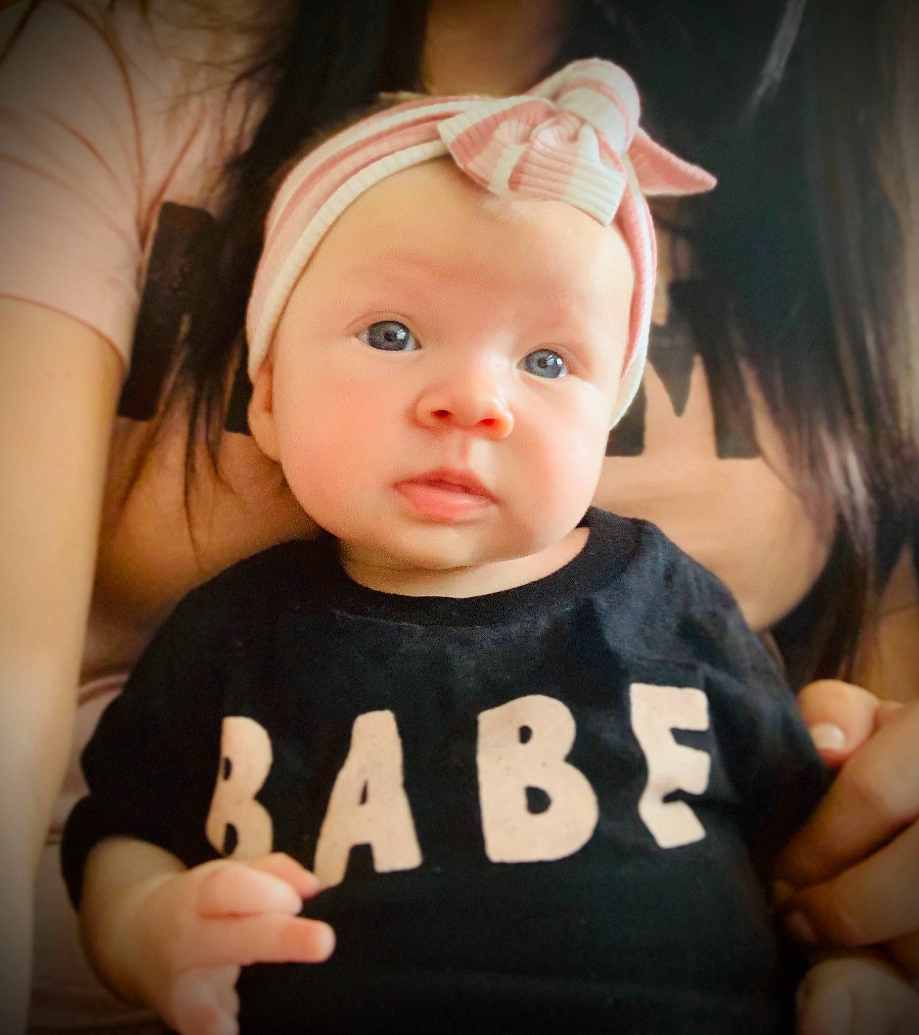 Taylor is registered to the contest to win money with this photo: baby, cheek, child, cool, ear, eye, face, finger, forehead, gesture, hand, head, headwear, lip, person, skin, t_shirt, thumb, toddler