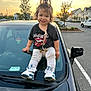 Jayley joined the competition — help win amazing prizes! child, toddler, smiling, sitting, car, parking_lot, sunset, trees, sneakers, leggings, tshirt, hair_tie, outdoor, asphalt, vehicle, reflection, facial_expression, person, daylight, casual_clothing