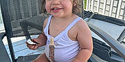 Jayley joined the competition — help win amazing prizes! toddler, child, smiling, cookie, white_top, pacifier_clip, outdoor, patio, chair, hair_tied, happy, summer, daylight, railing, greenery, seat, cute, baby, skin, portrait