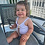 toddler, child, smiling, cookie, white_top, pacifier_clip, outdoor, patio, chair, hair_tied, happy, summer, daylight, railing, greenery, seat, cute, baby, skin, portrait
