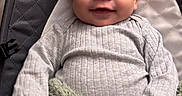 Micah is registered to the contest to win money with this photo: baby, infant, smile, face, eyes, clothing, blanket, quilted, seat, cozy, portrait, cute, child, person, indoor, soft_texture, baby_clothes, happy, young, closeup