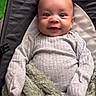 baby, infant, smile, face, eyes, clothing, blanket, quilted, seat, cozy, portrait, cute, child, person, indoor, soft_texture, baby_clothes, happy, young, closeup
