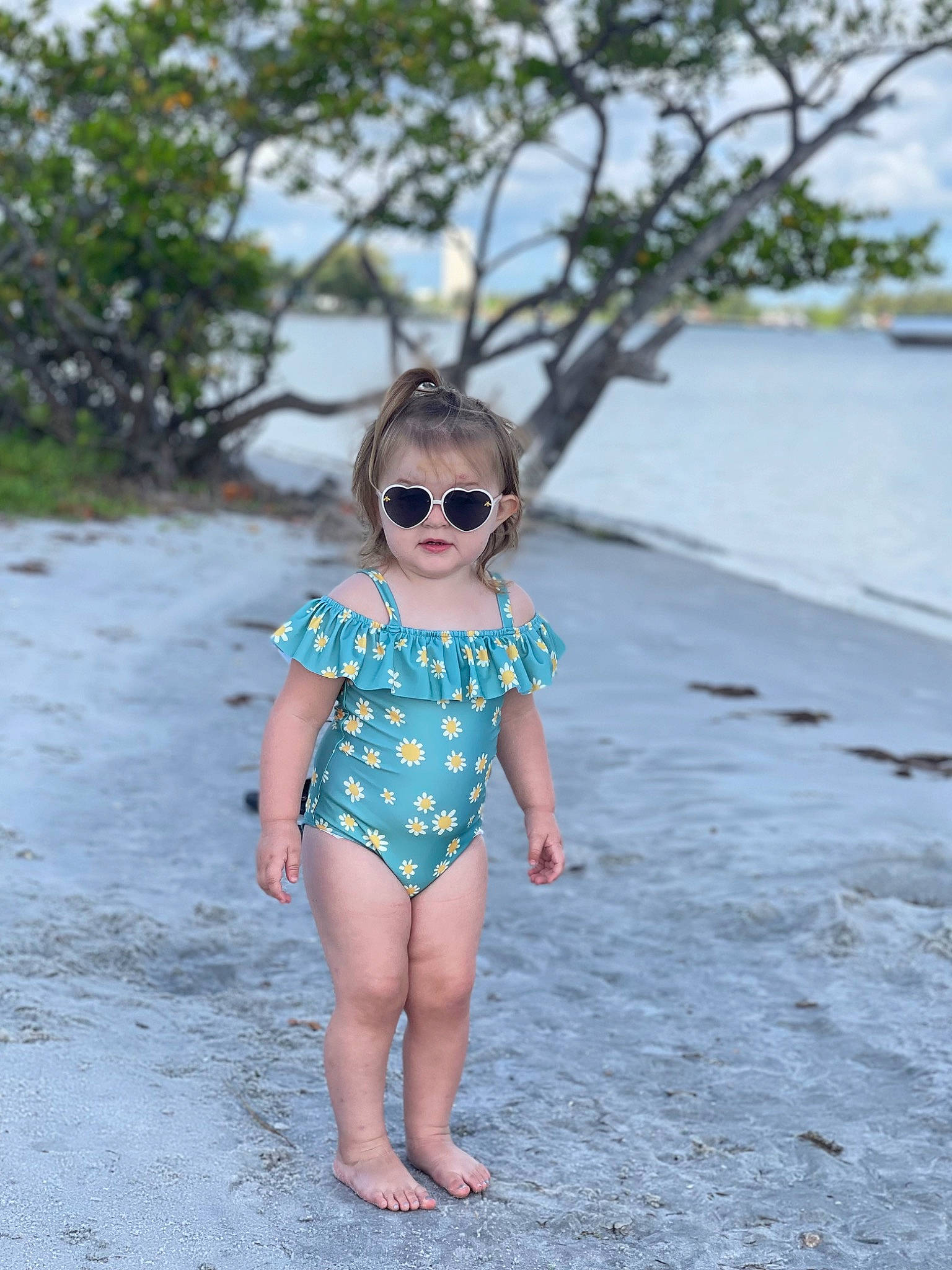 Amelia is registered to the contest to win money with this photo: baby_toddler_clothing, barefoot, cool, denim, dress, eyewear, glasses, goggles, happy, leisure, neck, outerwear, person, shoulder, sleeve, summer, sunglasses, t_shirt, tree, vision_care
