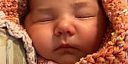 Octavia joined the competition — help win amazing prizes! baby, sleeping, blanket, knit, orange, cozy, infant, cute, soft, face, child, warm, wrapped, resting, peaceful, newborn, portrait, closeup, indoors, comfort