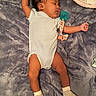 Nyielle is registered to the contest to win money with this photo: arms_outstretched, baby, bed, blanket, closed_eyes, cozy, curly_hair, cute, gray_blanket, indoors, infant, lying_down, onesie, pacifier, pacifier_clip, peaceful, portrait, sleeping, soft_lighting, striped_socks