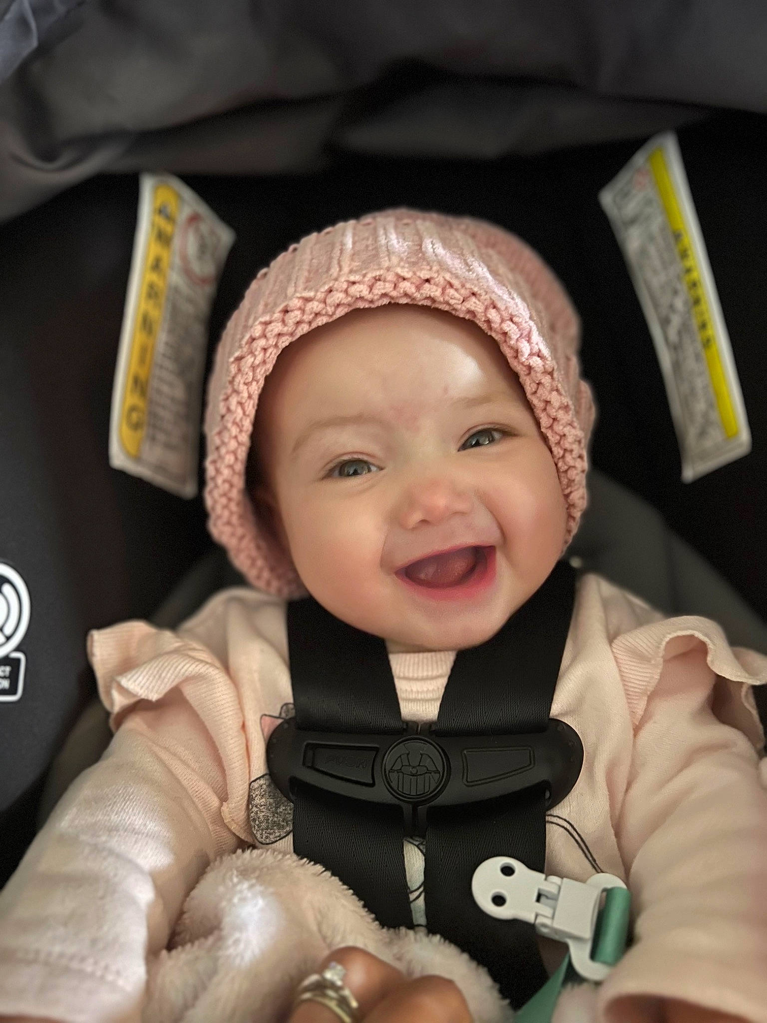Kiara is registered to the contest to win money with this photo: baby, baby_carriage, cap, cheek, comfort, eye, face, finger, gesture, happy, head, headgear, headwear, human_body, nose, outerwear, person, product, skin, smile