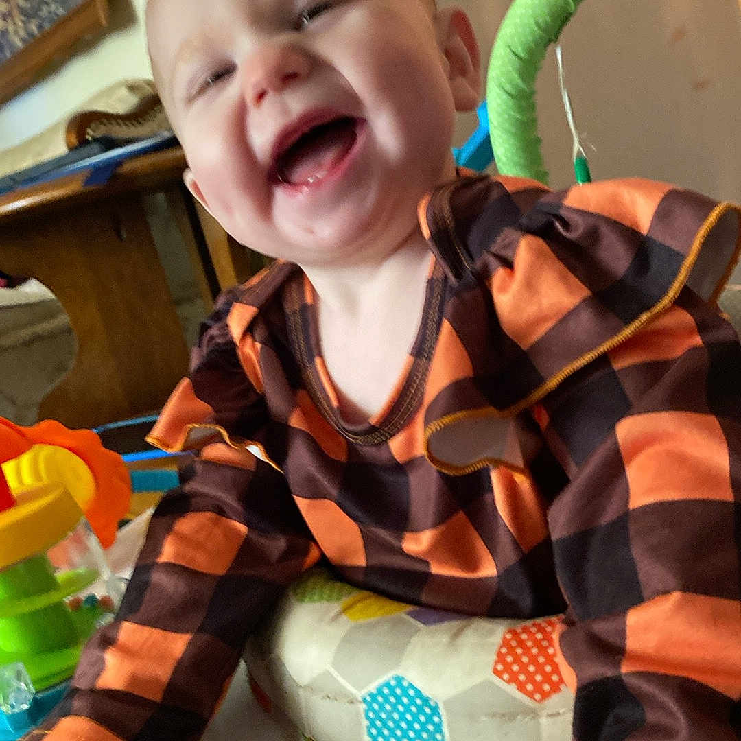 Nirvana joined the competition — help win amazing prizes! baby, bodypart, clothing, cutlery, face, furniture, happy, head, homedecor, indoors, laughing, mouth, person, photography, portrait, shirt, sitting, smile, teeth, toy