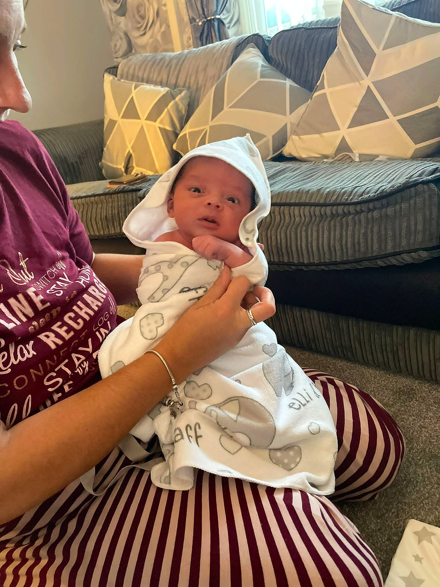 Ezrah joined the competition — help win amazing prizes! baby, baby_toddler_clothing, child, comfort, couch, event, fun, happy, hat, headwear, jewellery, lap, linens, pattern, person, pillow, room, sitting, t_shirt, textile