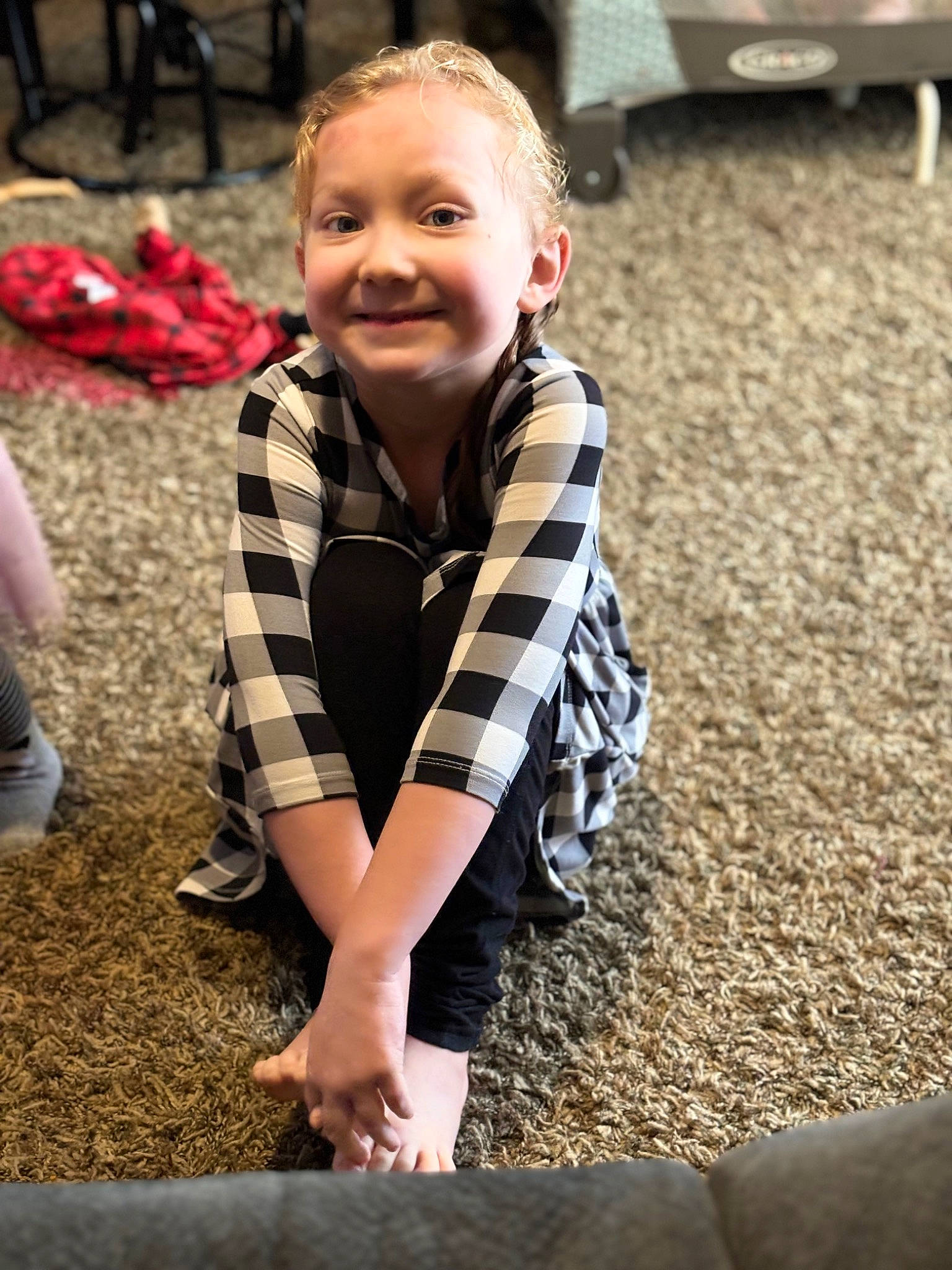 Elizabeth is registered to the contest to win money with this photo: blond, child, face, finger, flooring, fun, grass, hair, happy, human_leg, joy, leisure, pattern, people_in_nature, person, plaid, sitting, smile, soil, toddler