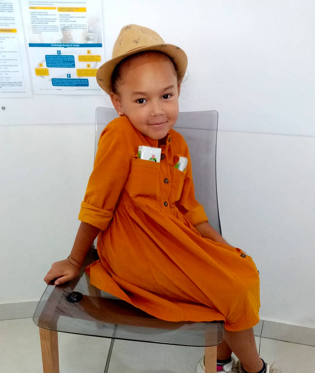Shirley a rejoint le concours — aidez-le/la à gagner de superbes lots ! baby_toddler_clothing, child, clothing, electric_blue, fashion_accessory, fashion_design, hat, joy, knee, orange, outerwear, pattern, peach, person, personal_protective_equipment, sitting, sleeve, standing, street_fashion, t_shirt