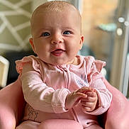 Wilma joined the competition — help win amazing prizes! baby, infant, pink_clothing, smiling, happy, child, portrait, indoor, seat, hands, face, blue_eyes, cute, young_child, soft_lighting, closeup, sitting, furniture, cozy, background_blur