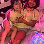 children, smiling, indoor, bed, toy, blanket, happy, family, sibling, child, casual_clothing, wall_photos, decor, playful, toddler, girl, infant, cozy, candid, home