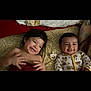 Violet joined the competition — help win amazing prizes! baby, toddler, smiling, bed, blanket, pacifier, onesie, child, cute, happy, indoor, patterned_sheet, sleepwear, lying_down, two_children, friendship, candid, family, infant, cozy