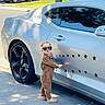 Emiliano is registered to the contest to win money with this photo: car, child, cute, fashionable, jumpsuit, outdoor, portrait, reflection, sandals, shadow, sidewalk, silver_car, sports_car, star_decals, street, sunglasses, sunlight, toddler, urban, wheel