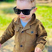 Emiliano is registered to the contest to win money with this photo: buttons, casual, child, cute, face, fashion, grass, hair, hand, happy, jacket, jumpsuit, outdoor, park, portrait, smile, sunglasses, sunlight, toddler, young_child