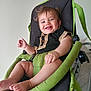 baby, barefoot, black, child, clothing, comfort, cute, foot, green, hand, happy, indoor, infant, person, portrait, relaxed, rocker, seat, smiling, young