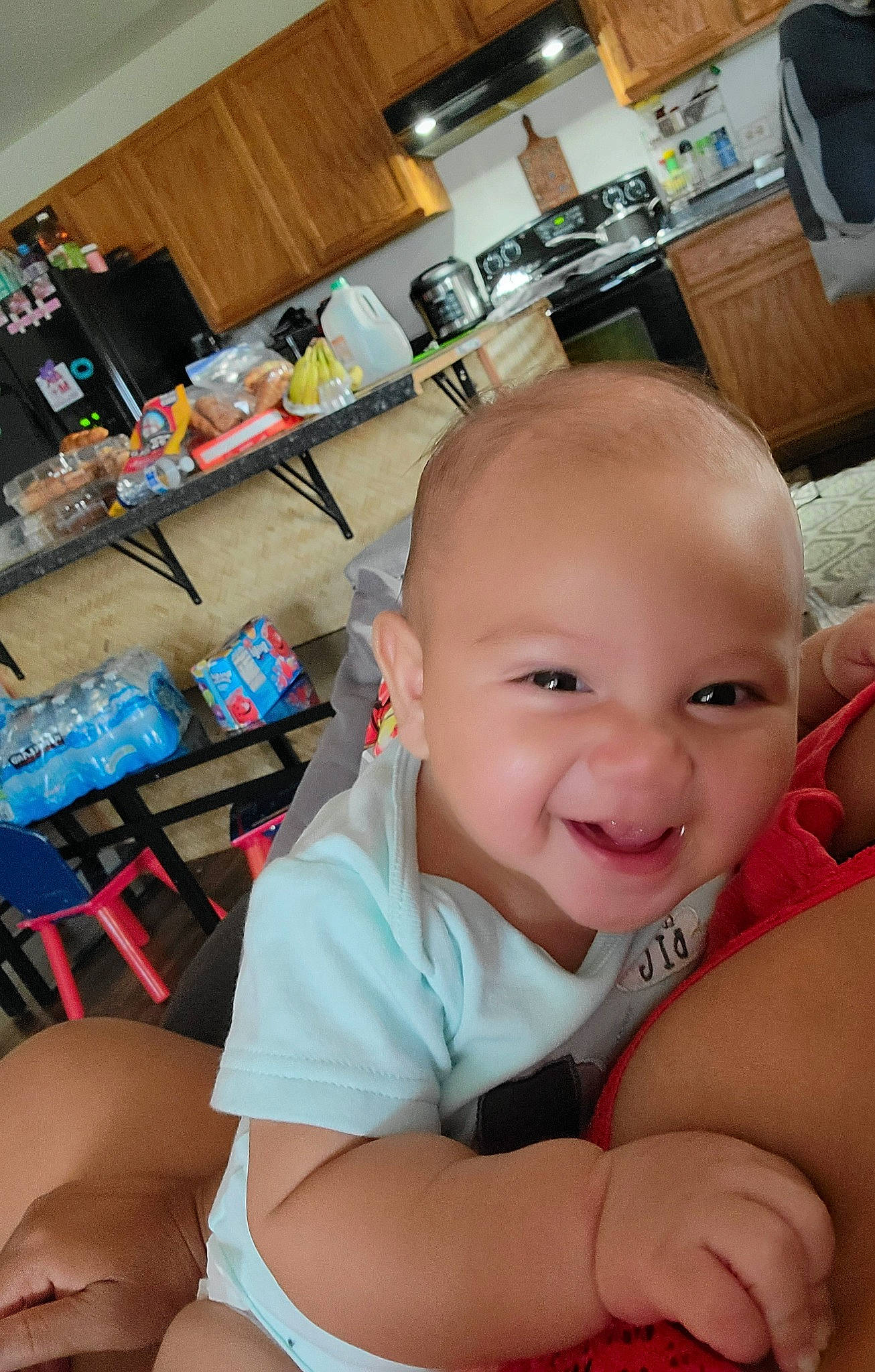 Kahiau is registered to the contest to win money with this photo: baby, baby_toddler_clothing, chair, cheek, child, comfort, flooring, fun, gesture, happy, iris, joint, joy, leisure, person, sitting, skin, smile, table, thigh