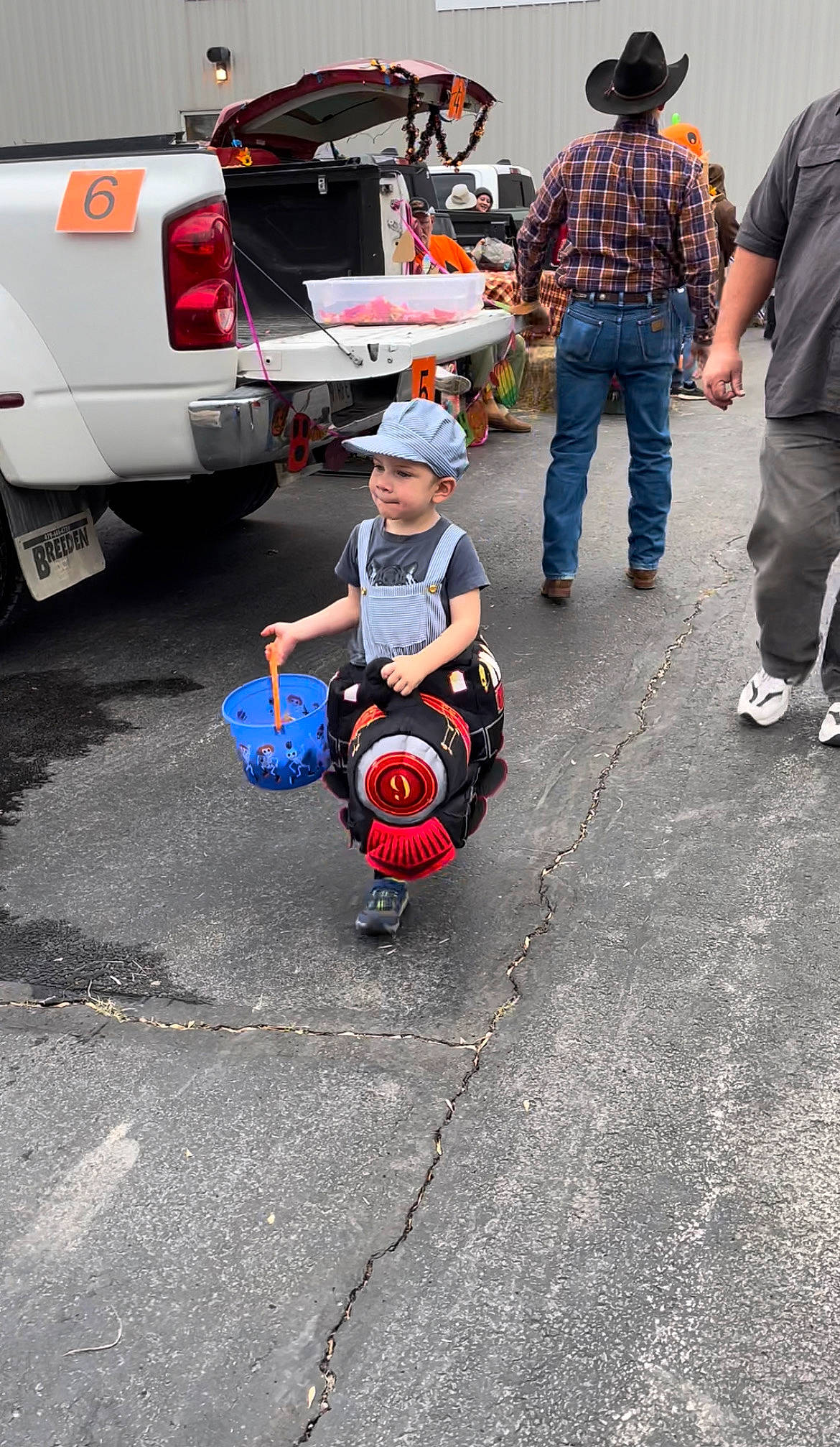 Dallas is registered to the contest to win money with this photo: asphalt, auto_part, automotive_design, automotive_exterior, automotive_lighting, automotive_tire, automotive_wheel_system, bumper, car, fender, headwear, motor_vehicle, person, public_space, road_surface, rolling, shoe, sneakers, tire, vehicle