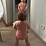Léna participe au concours pour gagner de l'argent avec cette photo : baby, child, cute, flooring, furniture, home, indoor, mirror, person, pink_onesie, reflection, reflection_face, reflection_pose, room, short_hair, soft_lighting, standing, toddler, wall_socket, wooden_floor