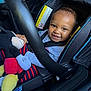 toddler, car_seat, child, smile, plush_toy, mickey_mouse, toy, safety_belt, happy, infant, clothing, seatbelt, car_interior, child_seat, cute, baby, person, portrait, striped_pants, closeup