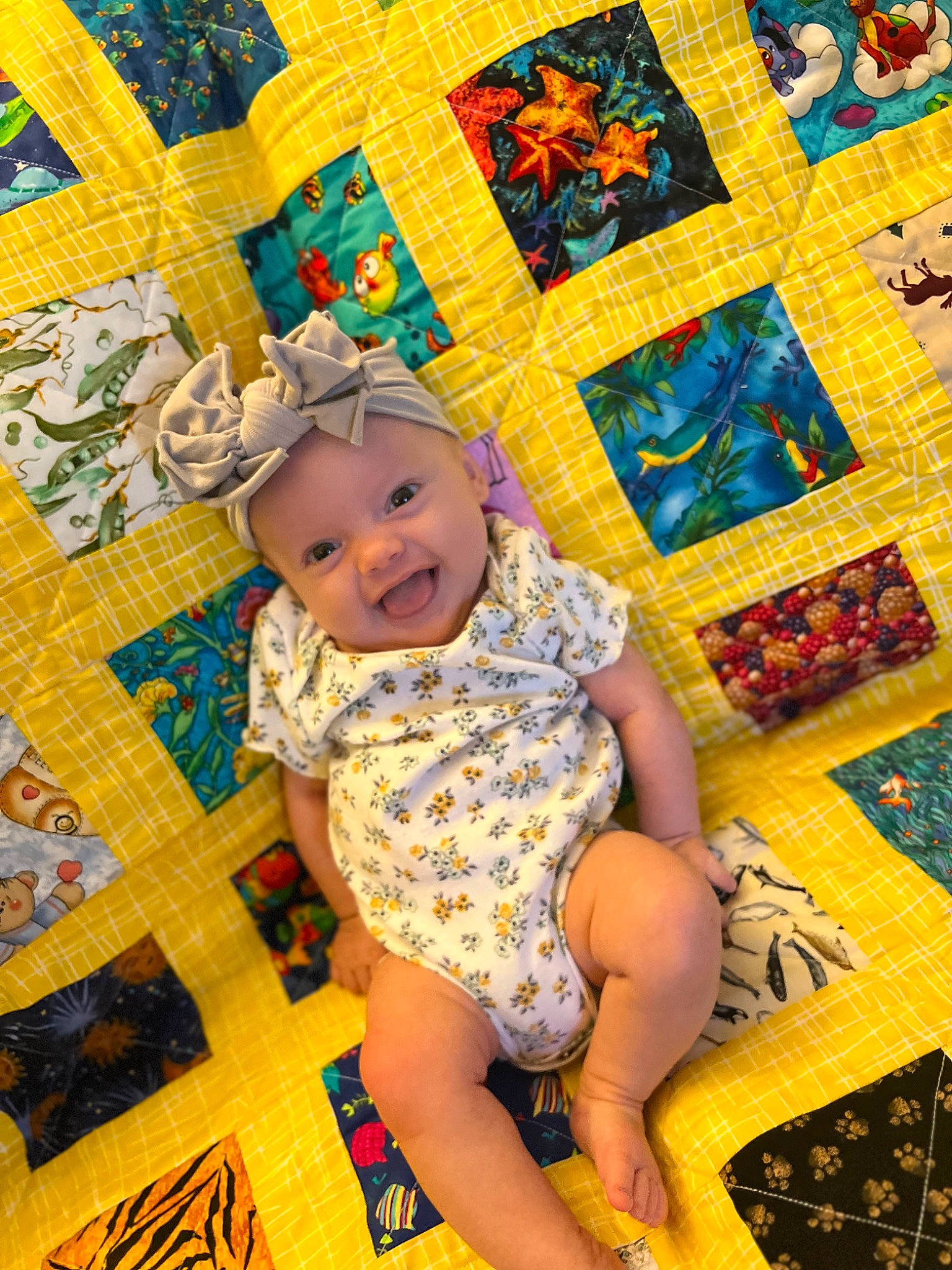 Elena is registered to the contest to win money with this photo: art, baby, baby_toddler_clothing, child, flooring, foot, fun, happy, headwear, human_leg, leisure, linens, pattern, person, purple, room, sandal, smile, textile, thigh