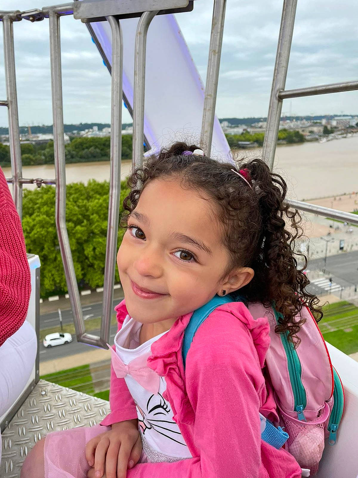 Nour participe au concours pour gagner de l'argent avec cette photo : child, city, fun, grass, happy, joy, leisure, magenta, outdoor_play_equipment, person, plant, pole, public_space, recreation, sky, smile, summer, swing, toddler, tourism