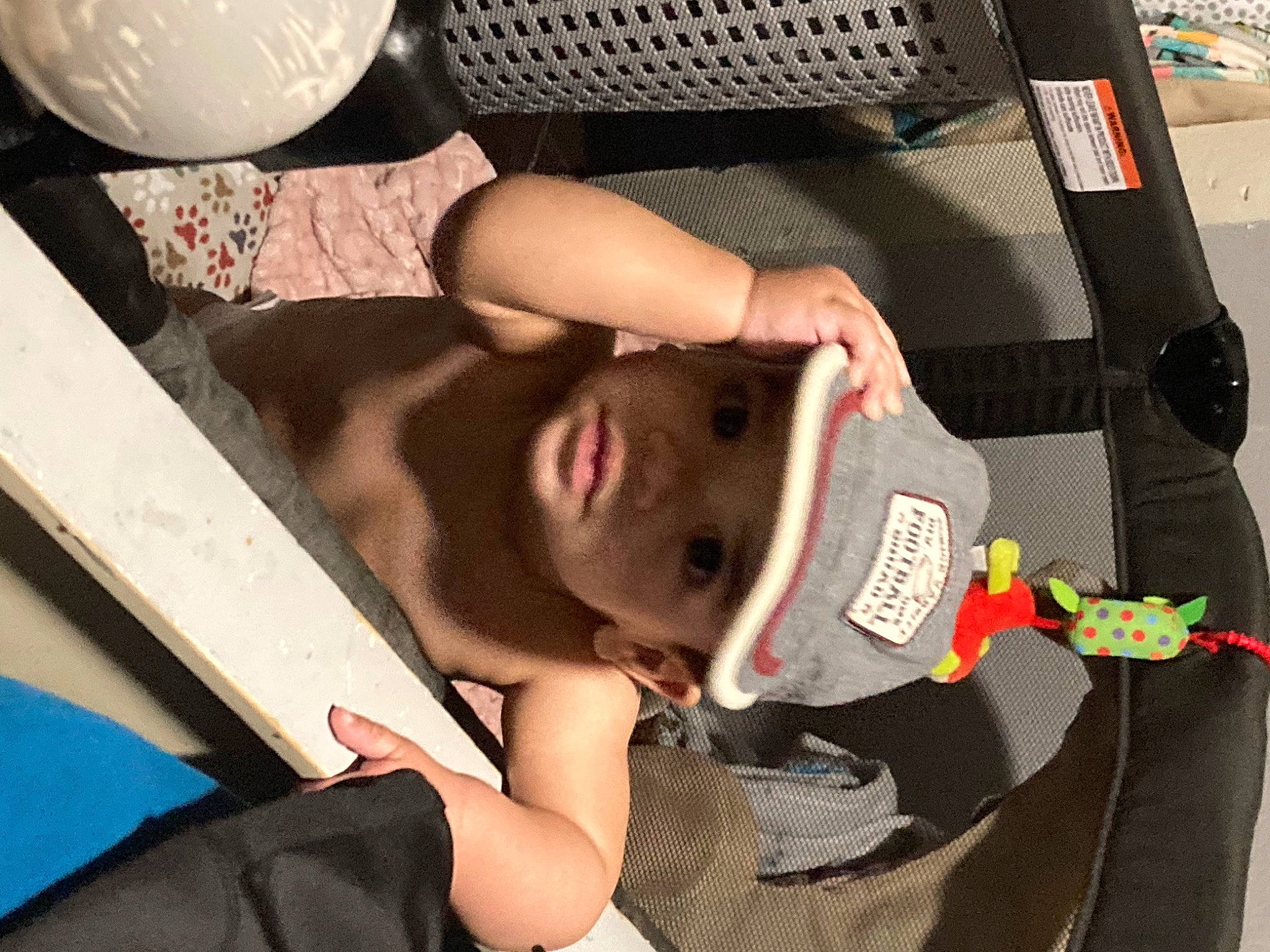 Alijah is registered to the contest to win money with this photo: audio_equipment, bag, balloon, chest, child, comfort, elbow, eyewear, flesh, fun, headwear, mouth, nail, pattern, person, room, sitting, wrist