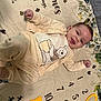 baby, infant, smiling, knitwear, winnie_the_pooh, milestone_blanket, numbers, heart_shape, lying_down, cozy, cute, celebration, soft_texture, playful, child, portrait, indoors, happy, toddler, clothing