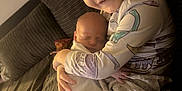 Caleb joined the competition — help win amazing prizes! affection, baby, blanket, child, couch, cozy, dinosaur_print, family, holding, indoor, love, newborn, pajamas, portrait, sibling, sleeping, smile, striped_couch, toddler, warm_lighting