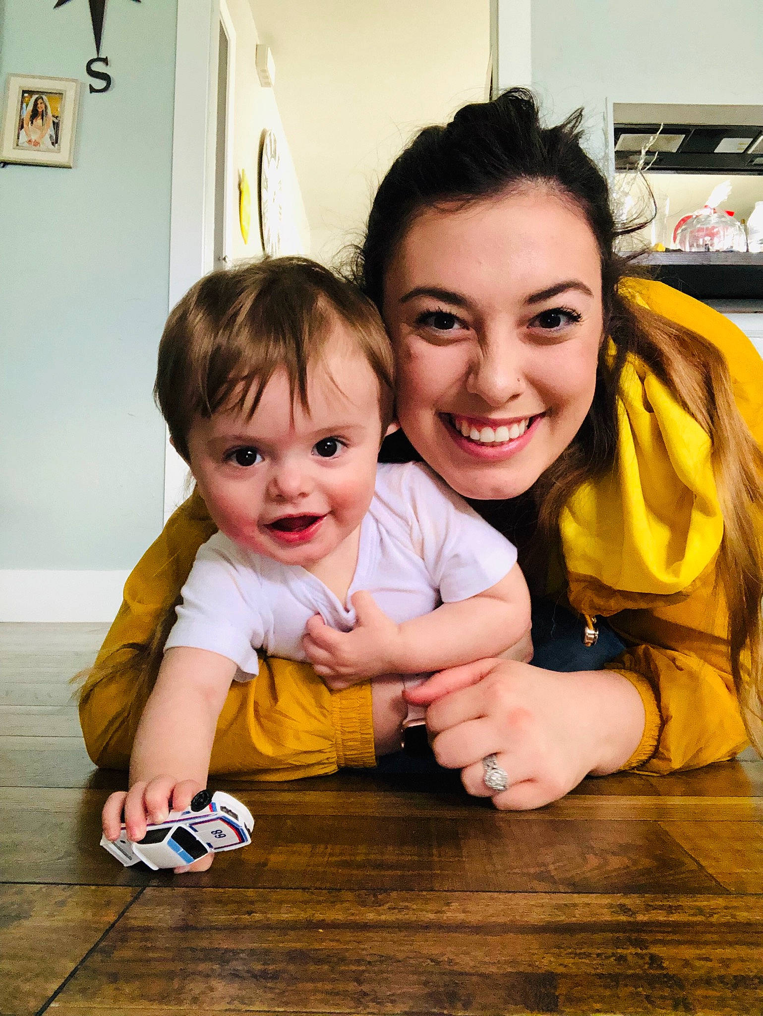 Haidyn is registered to the contest to win money with this photo: child, daughter, facial_expression, family, floor, flooring, fun, happy, joy, mother, people, person, photography, play, room, skin, smile, toddler, vacation, wood