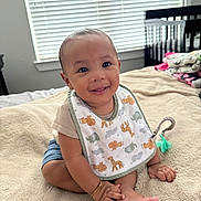 Mateo joined the competition — help win amazing prizes! baby, child, smiling, bib, blanket, bed, indoor, window, crib, happy, person, infant, clothing, cute, foot, hand, bracelet, room, natural_light, sitting