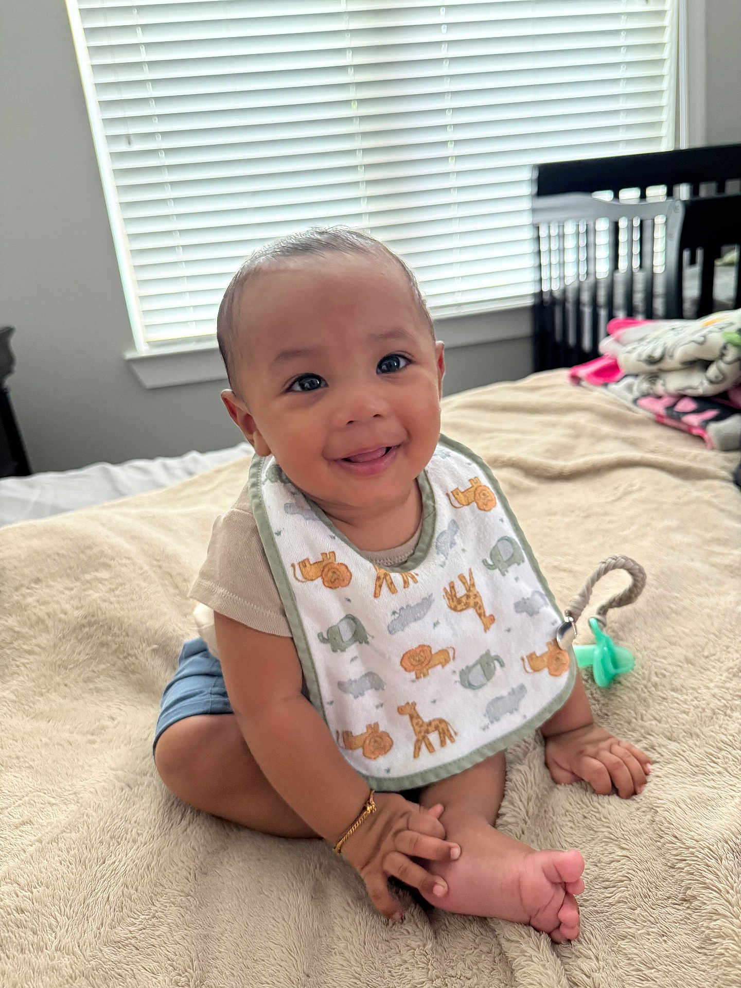 Mateo joined the competition — help win amazing prizes! baby, child, smiling, bib, blanket, bed, indoor, window, crib, happy, person, infant, clothing, cute, foot, hand, bracelet, room, natural_light, sitting